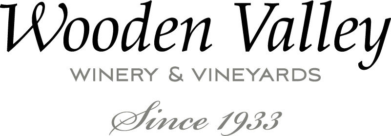 A green banner with the words golden valley winery and vineyard written in black.