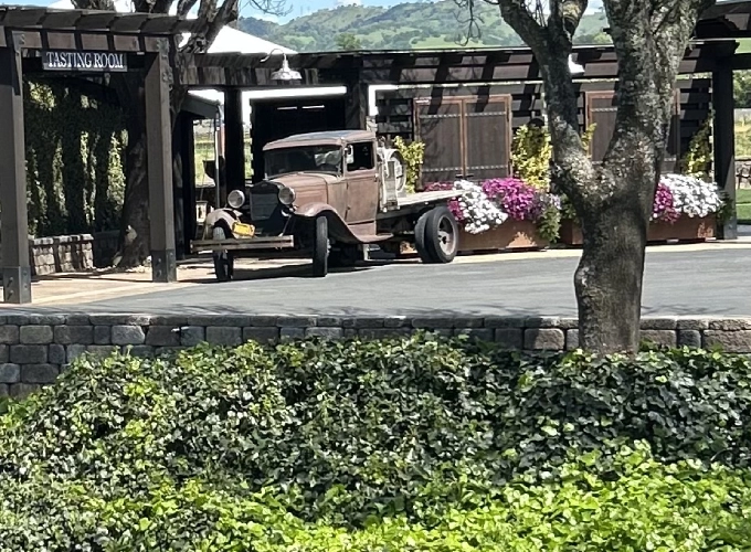 A vintage car parked in front of a building.