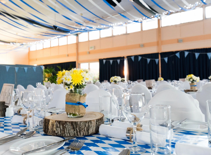 A table set up with blue and white checkered tablecloth.